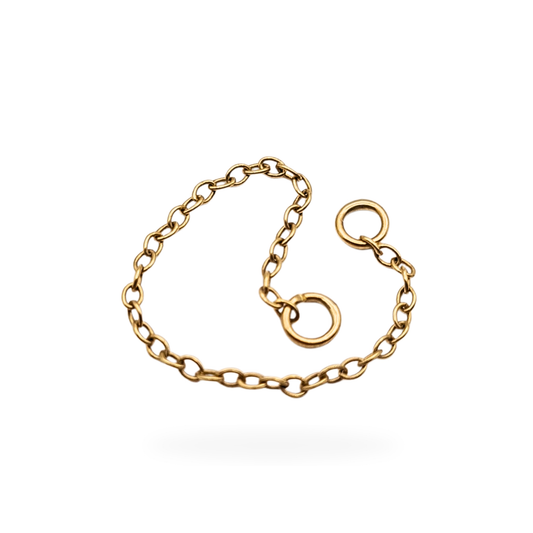 Close-up of a 9ct yellow gold safety chain with fine oval links and small jump rings at each end, measuring 2 inches (52 mm) long and weighing 0.13 g; tested as 9ct gold and displayed against a neutral background.