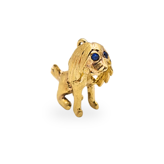 Solid 14ct gold dog charm measuring 15mm tall, 16mm long and 6mm wide, weighing 3.1g. Detailed textured finish with blue stone set eyes, not hallmarked but fully tested as 14ct gold, ideal for a charm bracelet or gold pendant necklace.

