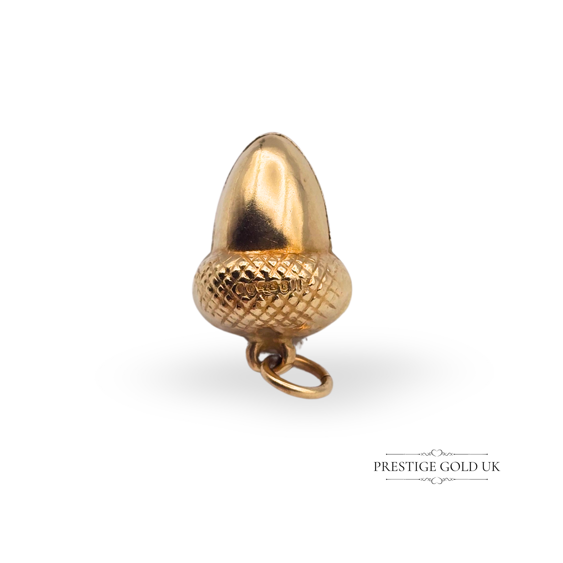 Vintage 9ct gold acorn charm pendant with a textured cap and smooth body, fully hallmarked London 1989, hollow construction, 16mm tall, weighs 0.7g, nature-inspired keepsake or gift.
