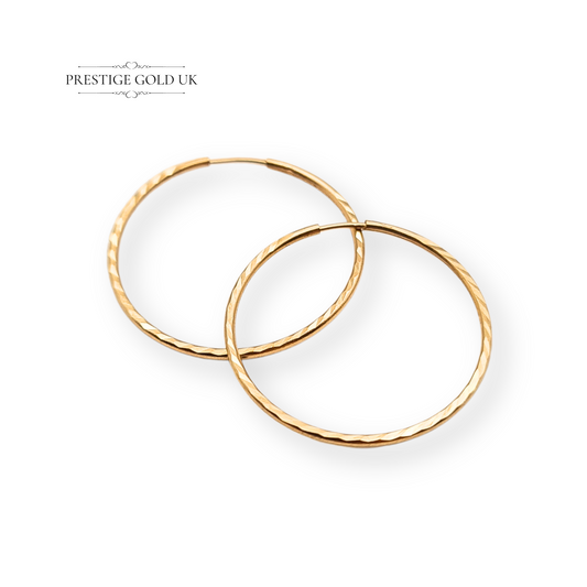 Pair of 9ct gold hoop earrings with chevron pattern, stamped 375 and fully tested, measuring 18mm in diameter and 1mm thick. Lightweight 0.32g sleepers, dainty and comfortable for everyday wear, classic small gold hoop design.