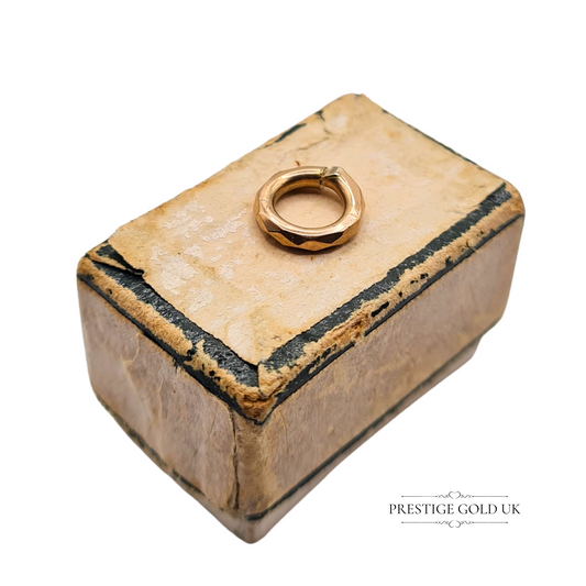 Close-up image of a 0.48g 9ct yellow gold jump ring with textured edge, 0.8mm diameter, ideal as a vintage-style jewellery finding or charm bracelet component.
