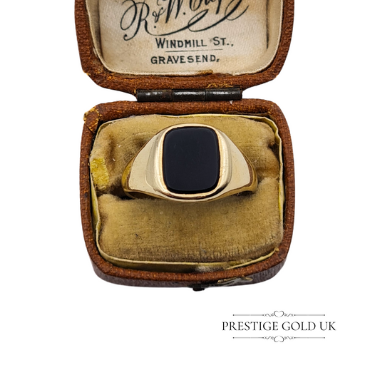 Close-up of a vintage 9ct gold onyx signet ring with a square black gemstone and minimalist design, fully hallmarked Birmingham 1970.