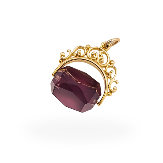 Vintage 9ct gold spinning purple quartz fob pendant with ornate scrollwork mount, London 1990, 21mm.