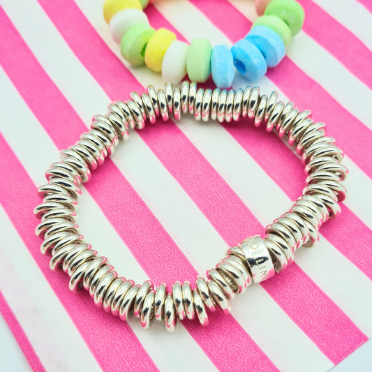 Sterling silver Links of London bracelet with polished ring link design and elastic stretch construction, 15cm small size, heavy 51g weight, featuring branded barrel fitting, shown on wrist and ruler for scale with close-up detail of links