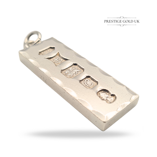 Solid 925 sterling silver large ingot pendant weighing 29.40 grams, measuring 46mm x 15mm x 4mm, hallmarked Birmingham 1977 with maker’s mark EJLD, anchor, lion passant, letter C date mark, duty mark, polished with fancy faceted edges.