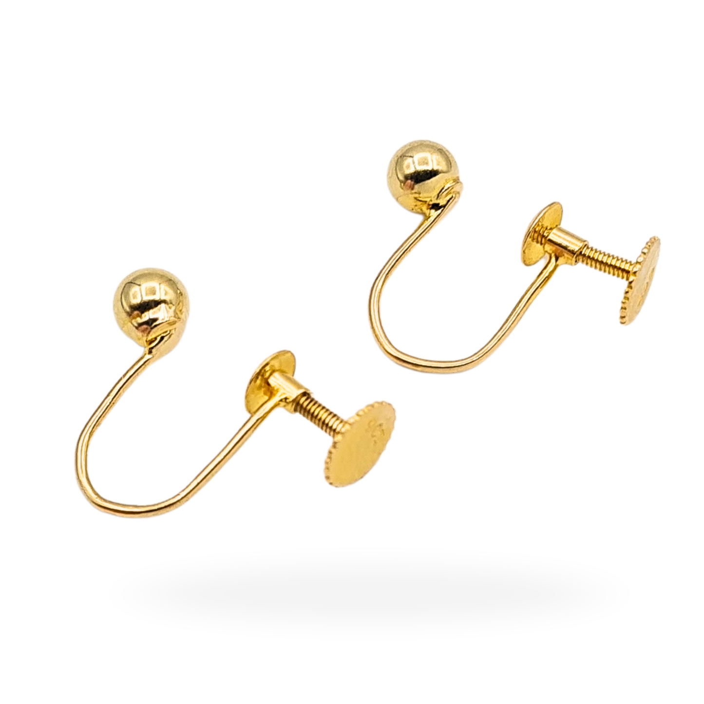 Pair of solid 9ct yellow gold screw back earrings featuring smooth 4mm ball studs, fully tested and stamped 9ct. Lightweight 0.86g design with secure threaded backs, photographed on vintage box and shown worn for scale.