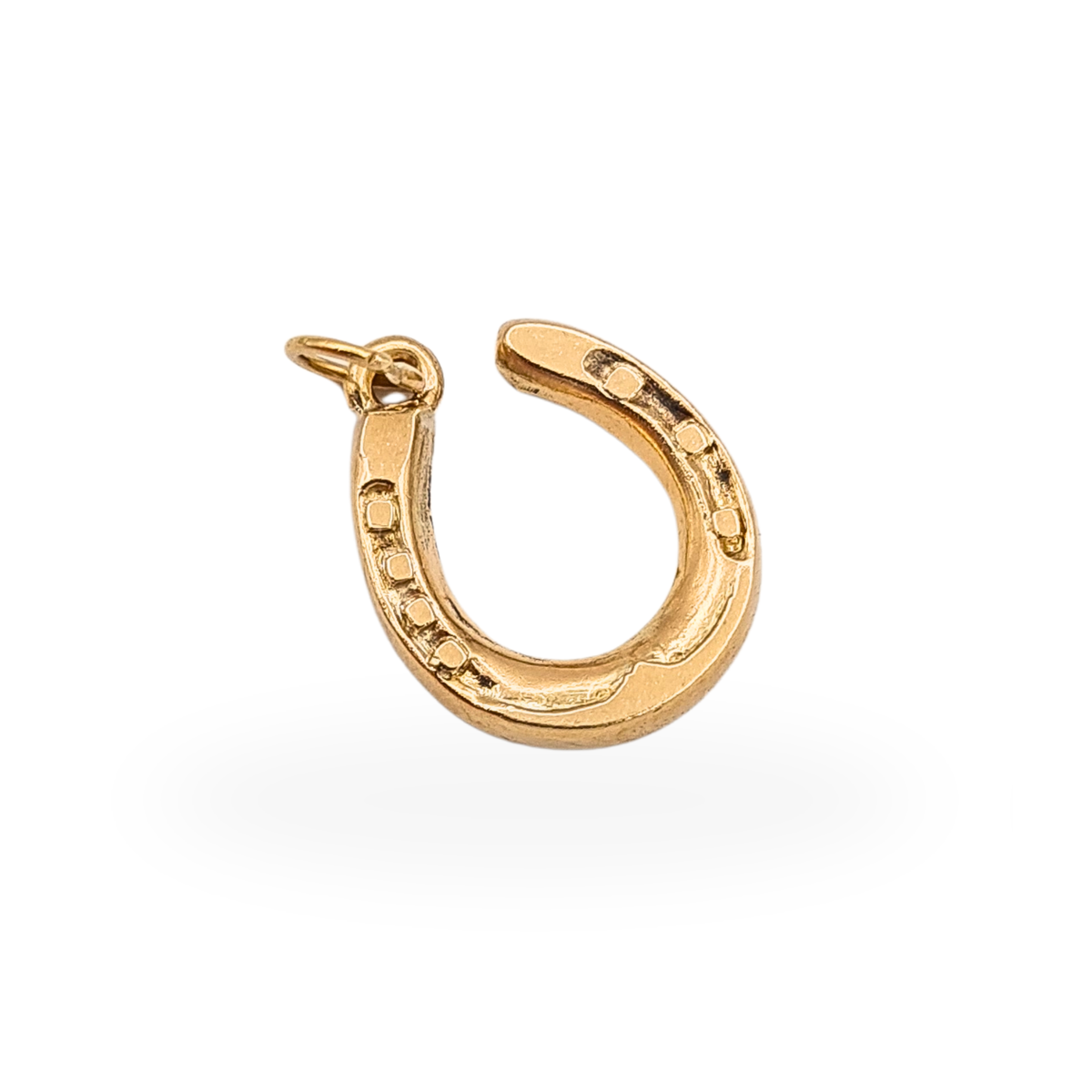 9ct yellow gold small horseshoe charm with raised nail details and jump ring