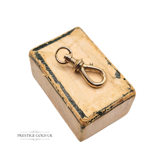Lightweight 9ct yellow gold antique screw clasp, 17mm x 6mm, with threaded locking mechanism and dog clip design, ideal for vintage charm bracelets or pendant connections, weighing just 0.78g.
