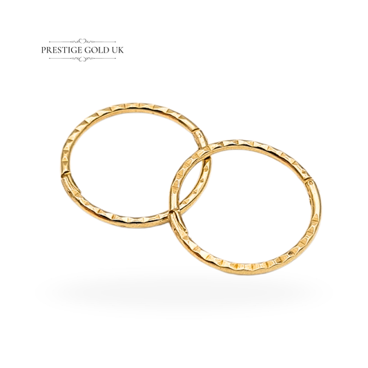 Pair of small 9ct yellow gold hinged hoop earrings with chevron pattern on one side, 10mm diameter, 0.55g, lightweight tested gold, shown on model and vintage box by Prestige Gold UK, minimalist design for everyday wear.