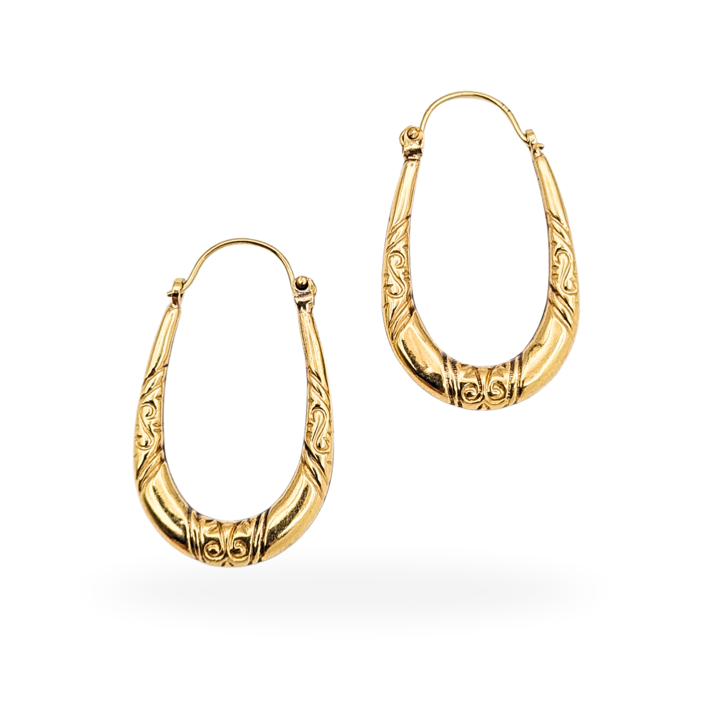 Pair of 9ct gold oval creole hoop earrings with engraved detailing, measuring 26mm tall by 15mm wide and 3mm thick. Stamped 375, fitted with flip-top fasteners, and weighing 1.14g. Polished yellow gold finish with elegant vintage-style engraving.
