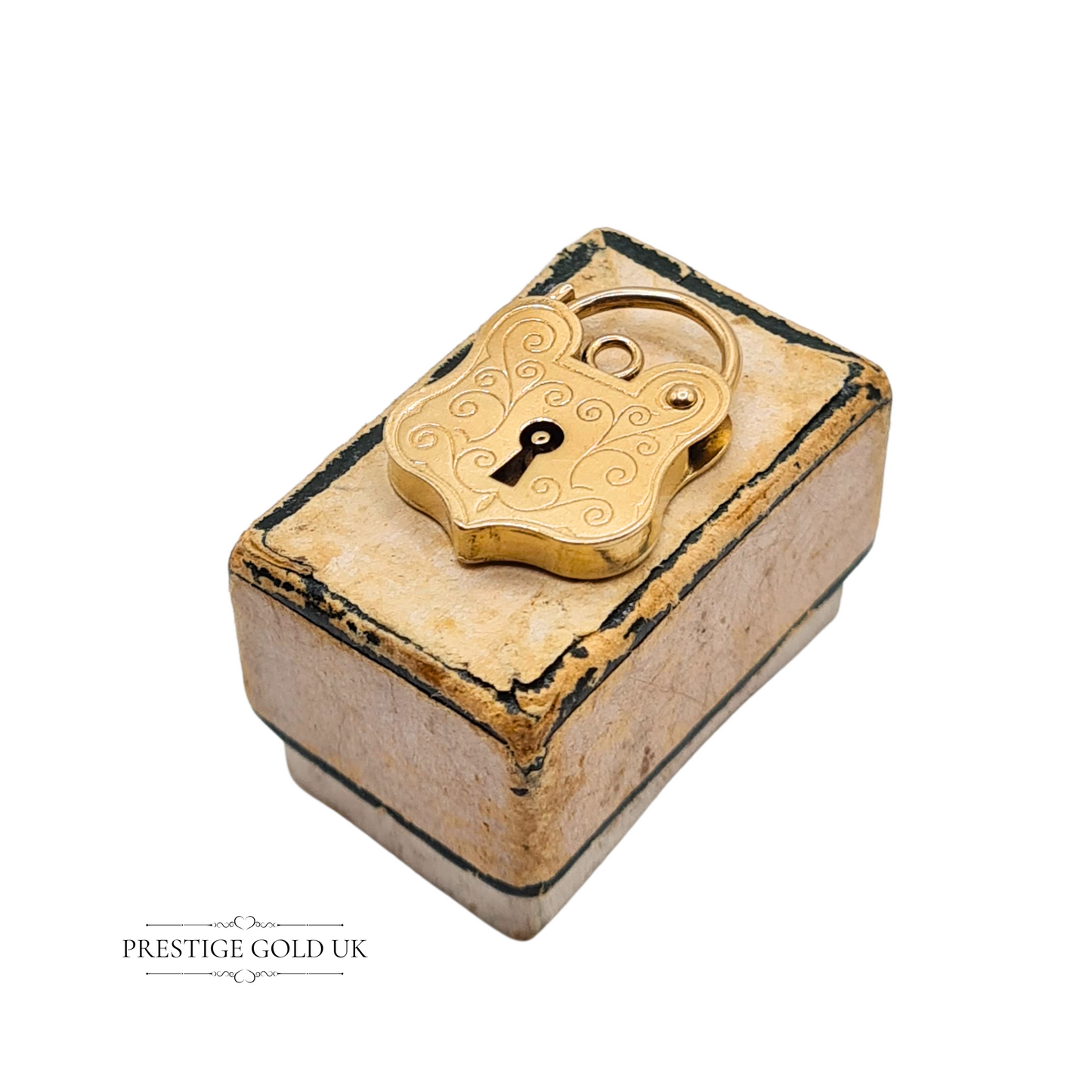 Vintage 9ct yellow gold heart-shaped padlock charm with scroll engraving, fully hallmarked London 1997, shown against ruler and hand for scale
