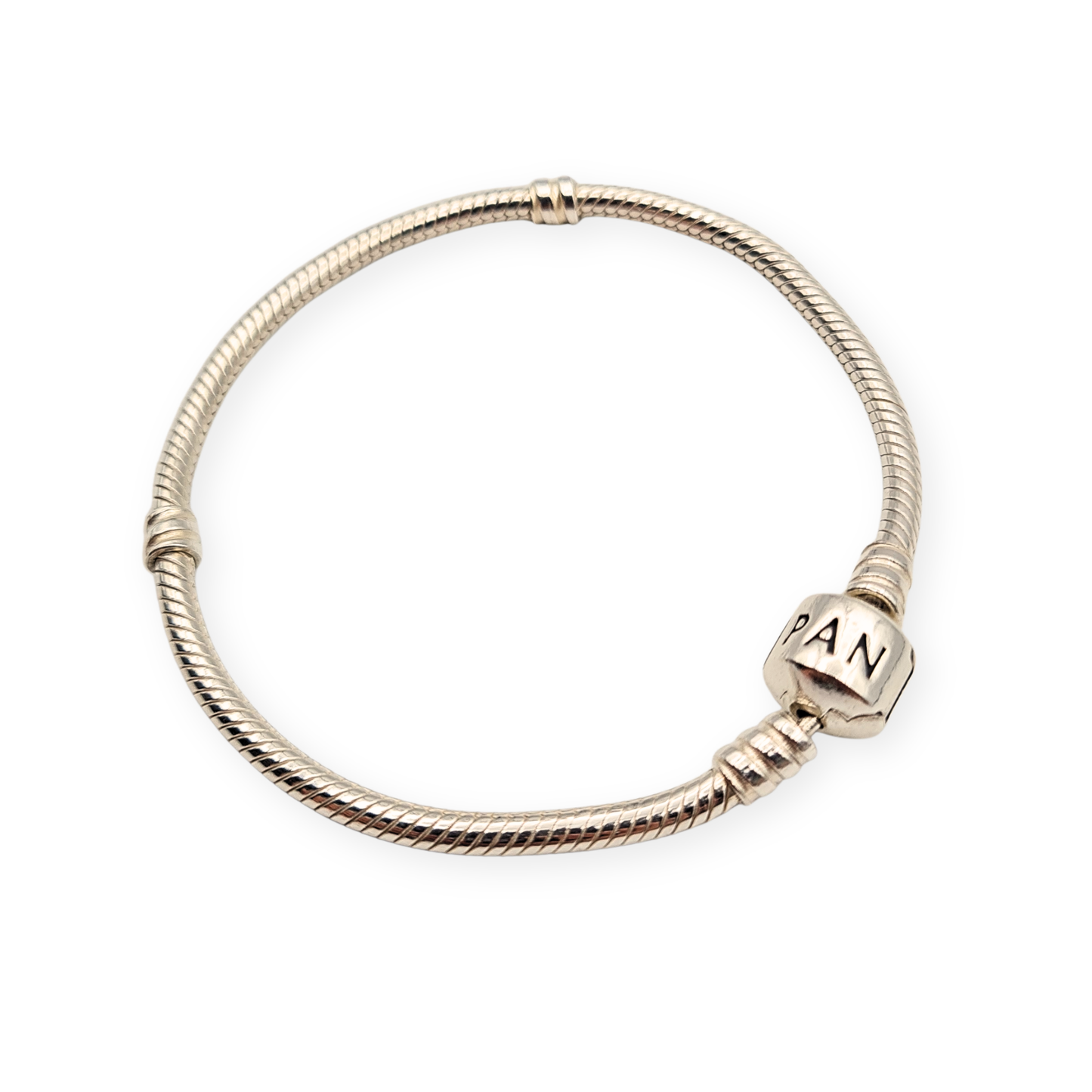 Close-up of a 7-inch Pandora sterling silver snake chain bracelet, fully hallmarked with iconic barrel clasp engraved “Pandora,” weighing 14.5g, showing slight kink when laid flat but smooth and flexible when worn.