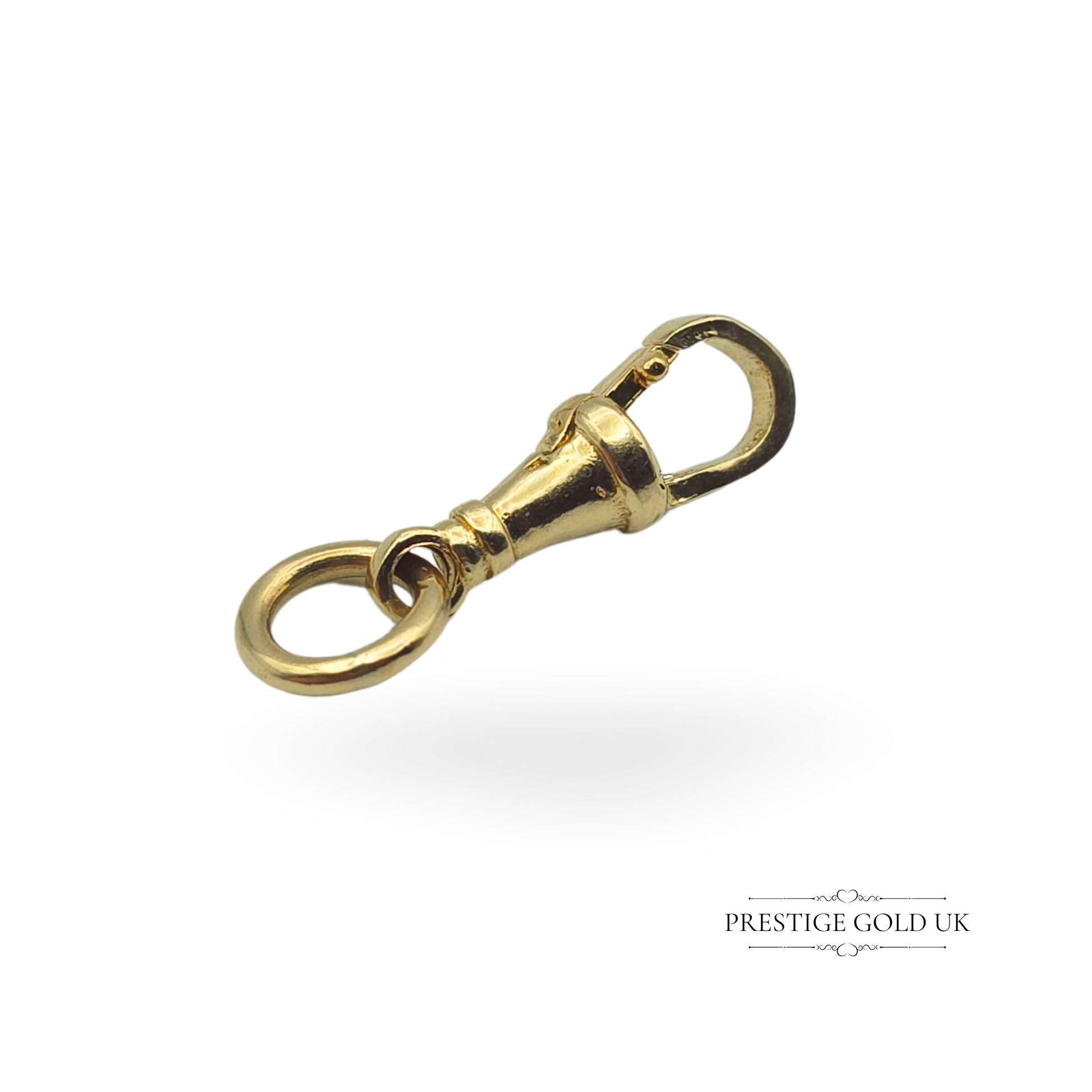 Vintage 9ct gold dog clip with a secure locking mechanism, photographed on a finger to highlight its size and detail.