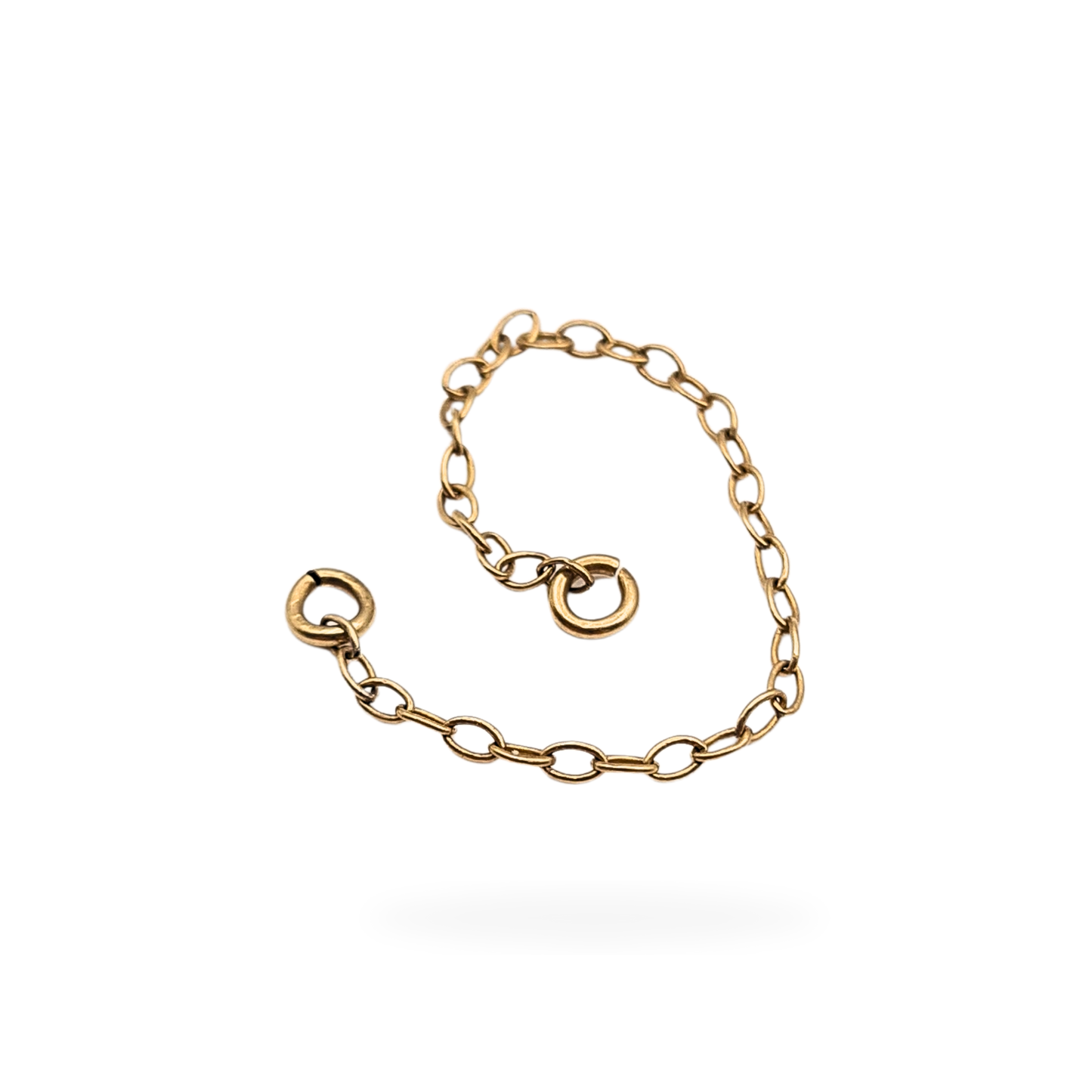 Close-up of a 9ct yellow gold safety chain with fine oval links and small jump rings at each end, measuring 2 1/4 inches (56 mm) long and weighing 0.19 g; tested as 9ct gold and displayed against a neutral background.