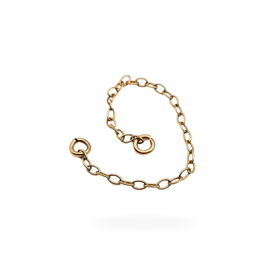 Close-up of a 9ct yellow gold safety chain with fine oval links and small jump rings at each end, measuring 2 1/4 inches (56 mm) long and weighing 0.19 g; tested as 9ct gold and displayed against a neutral background.