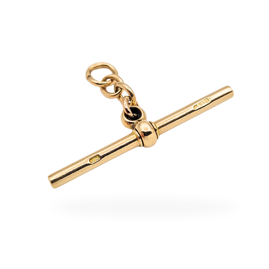 Solid 9ct yellow gold spinning T-bar pendant stamped 375, measuring 43mm long and 3mm wide, weighing 5.4g. Classic Albert chain style fitting with jump rings, polished finish and fully hallmarked gold. Ideal for pocket watch chain or necklace conversion.