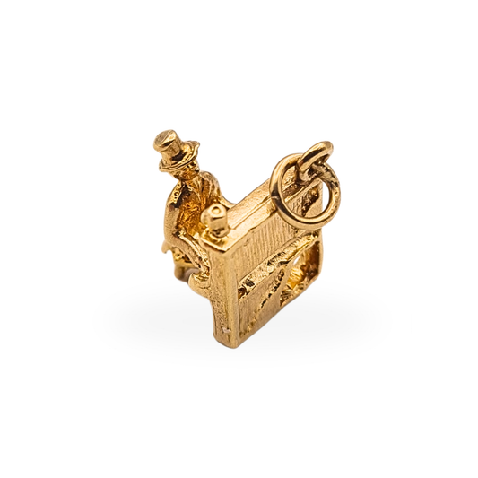Vintage 9ct yellow gold charm of a gentleman playing a grand piano, fully British hallmarked.
