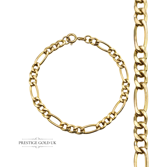A vintage 9ct gold Figaro bracelet with a Birmingham import hallmark, laid flat to display its full length.