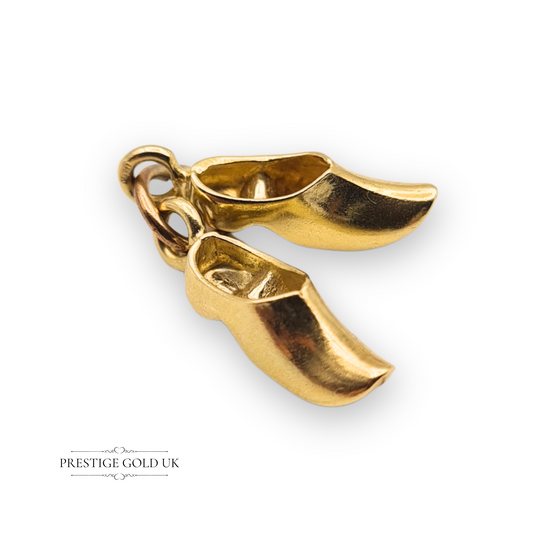 Pair of 9ct yellow gold Dutch clog charms with stamped 375 hallmark, measuring 16mm by 5mm each, linked by a jump ring, traditional shoe design ideal for charm bracelet or necklace.