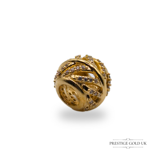 "14ct gold Pandora 'Light as a Feather' charm bead with cubic zirconia detailing, measuring 10 x 8mm, marked G585 ALE, shown with scale and hand for size reference."