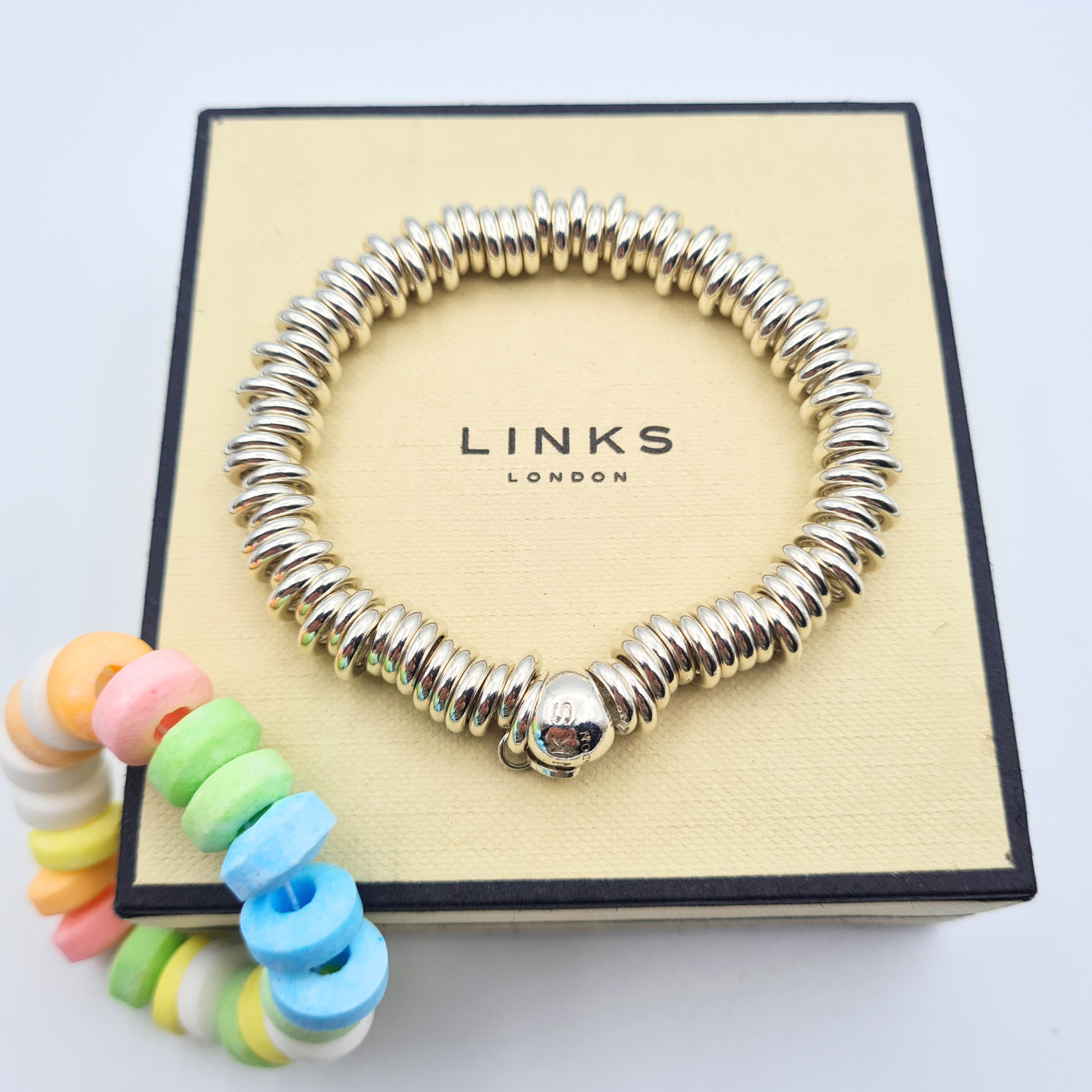 Sterling silver Links of London Sweetie bracelet with polished bead ring design, elasticated fit measuring 15.5cm, fully hallmarked with branded charm, chunky silver bracelet shown on wrist and presentation box