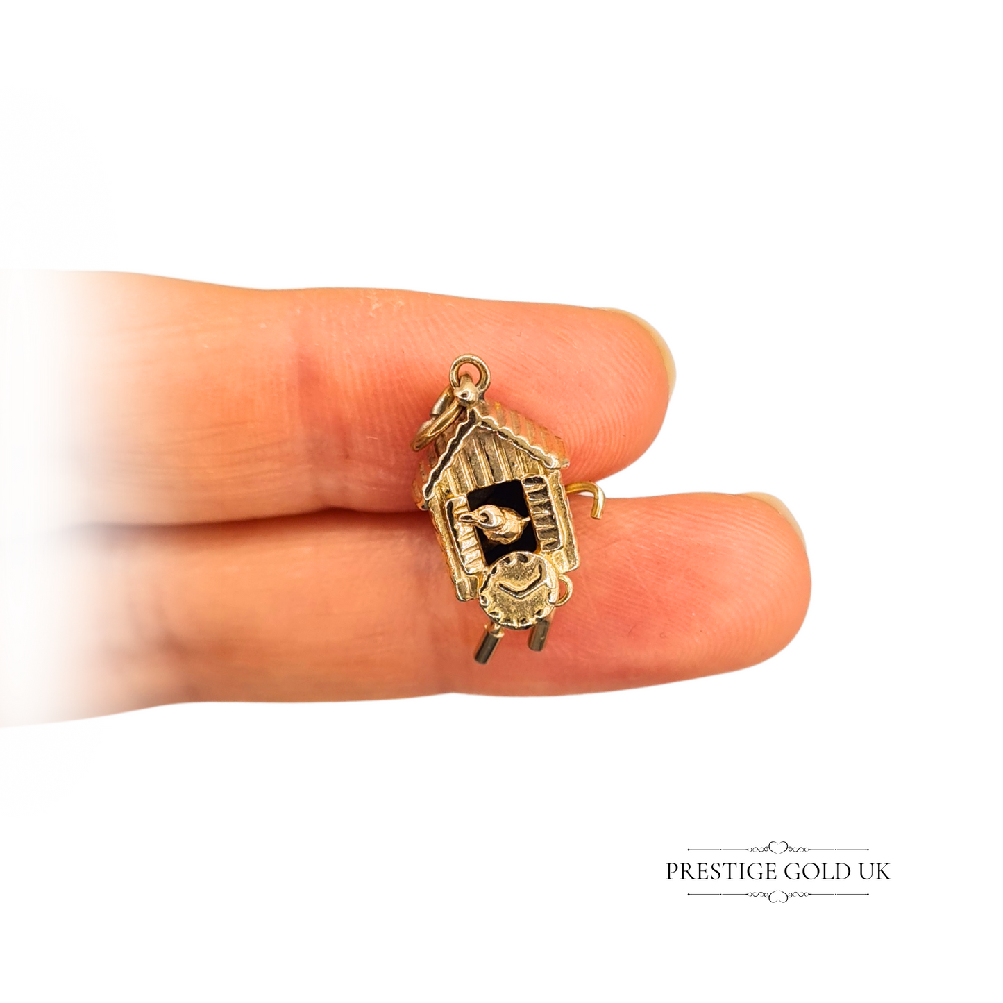 9ct gold cuckoo clock charm featuring a moving bird, measuring 20mm by 10mm, vintage novelty design with intricate details and a very worn hallmark