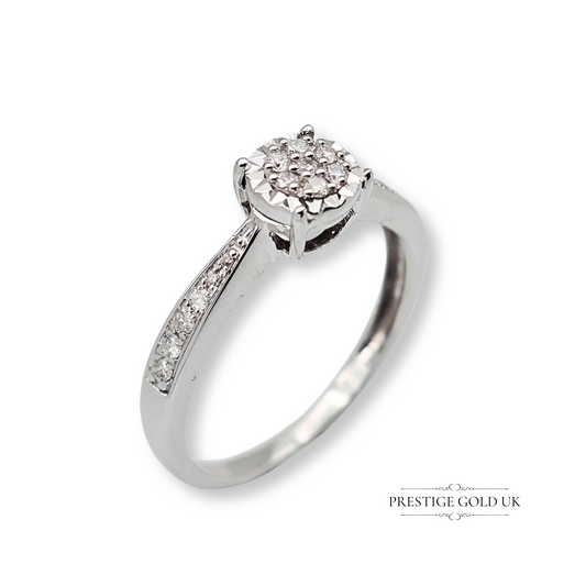 Refurbished 9ct white gold engagement ring featuring an illusion-set diamond with pavé-set shoulders, claw setting, and a polished rhodium finish in UK M / US 6 1/4 size.