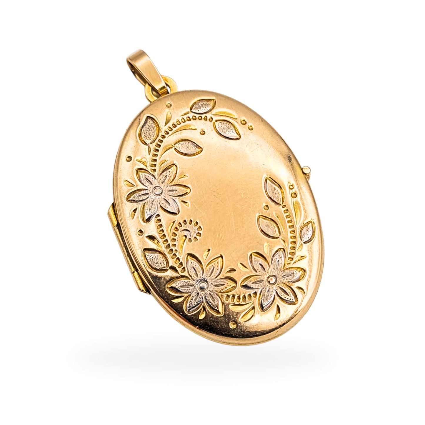 Vintage 9ct yellow and white gold oval locket weighing 3.42g, fully British hallmarked. Features detailed floral engraving with white gold flower accents, measuring 30mm tall by 20mm wide with space for two photos inside.