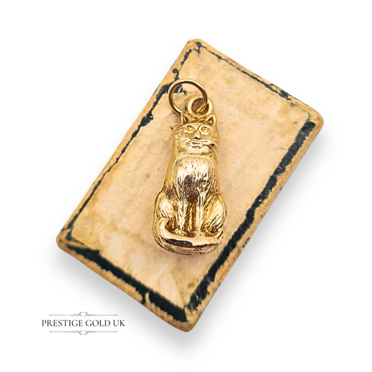 Vintage 9ct yellow gold small cat charm pendant weighing 0.70 grams, hollow construction with detailed design, 19mm tall by 8mm wide, hallmarked Birmingham 1960, perfect for charm bracelets and necklaces.