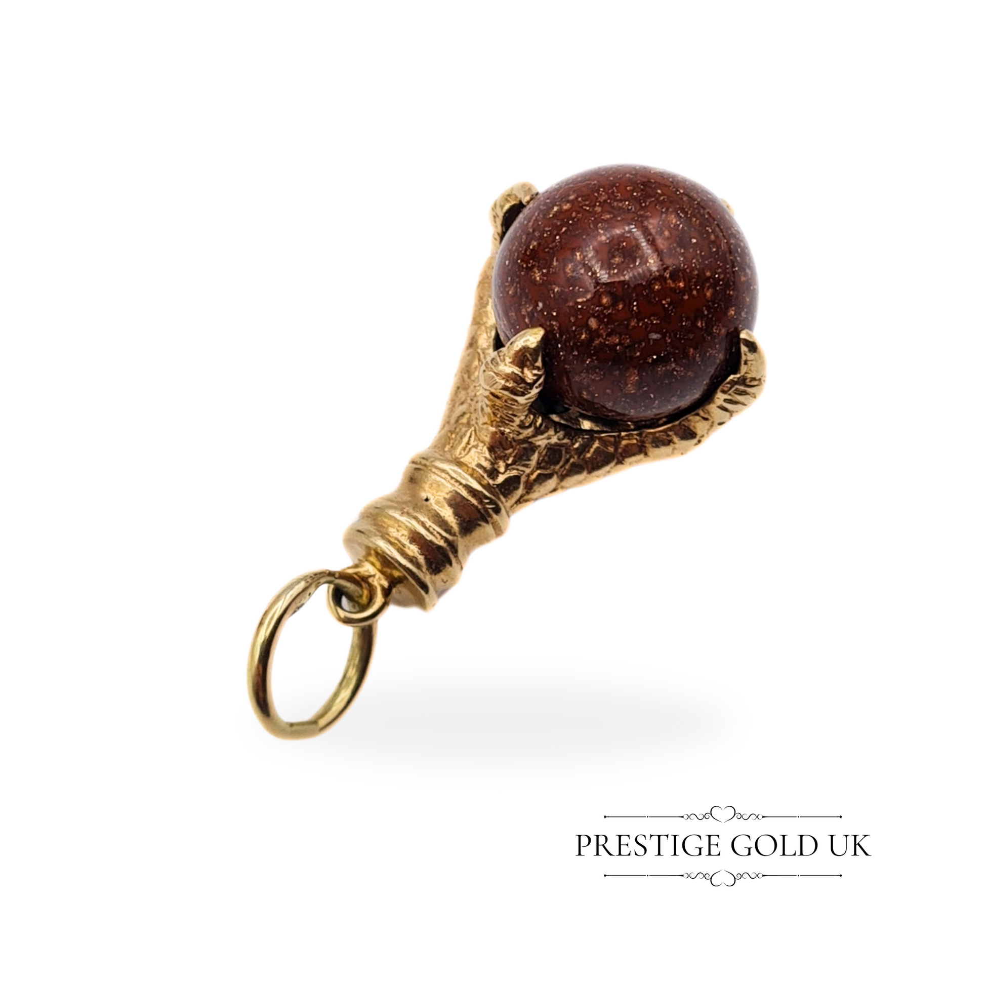 Full view of the vintage claw charm on a white background, highlighting the spinning moonstone centre.
