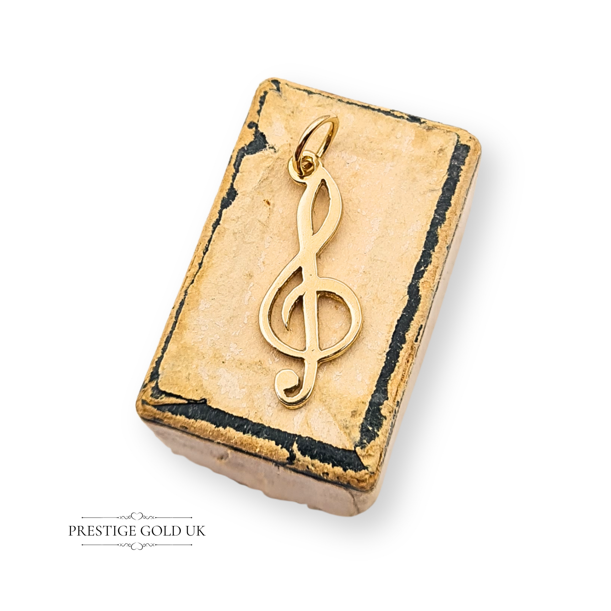 Vintage 9ct gold treble clef pendant charm, Birmingham 1987 hallmark, measuring 20mm x 8mm and weighing 0.54g. Dainty unisex gold music note jewellery, perfect as a musician’s gift or collectible vintage charm.