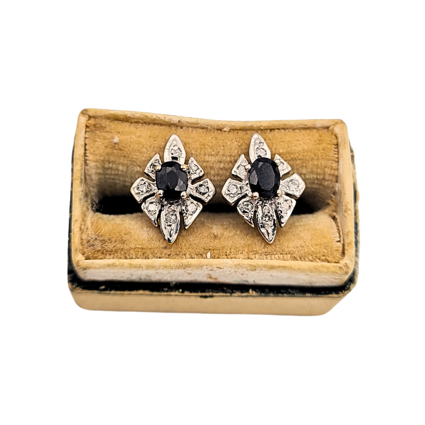 Pair of 9ct gold kite-shaped stud earrings set with oval sapphires and illusion-set diamonds. Fully hallmarked yellow gold with white-toned settings, measuring 11 x 8mm to the face. Elegant petite sapphire and diamond earrings with post and butterfly fittings.
