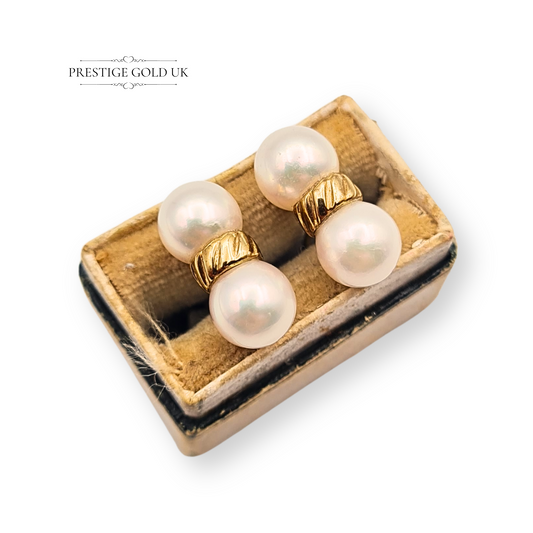 Pair of vintage 9ct gold twin pearl stud earrings, fully hallmarked, 15mm x 6mm, with double cultured pearls and butterfly backs, weighing 3.7g, classic textured gold centre band, elegant vintage pearl jewellery design.
