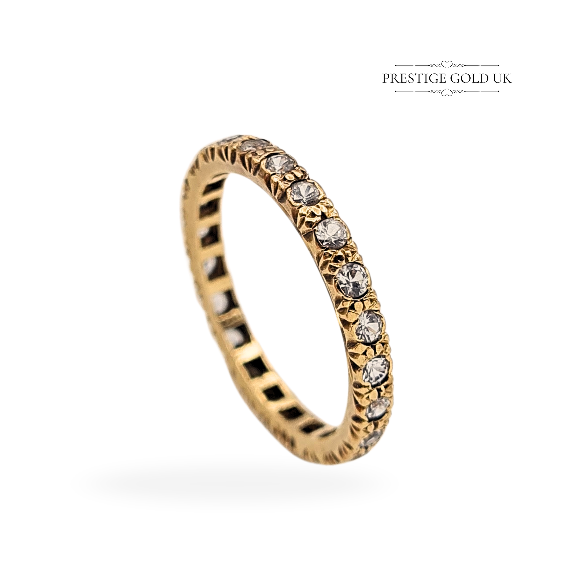 Vintage 9ct yellow gold full eternity ring set with round white spinels. Tested and stamped 9ct, 2.00g weight, 2.5mm wide band, UK O / US 7. Features ornate star-claw settings and polished finish, ideal as a stacking or wedding ring.
