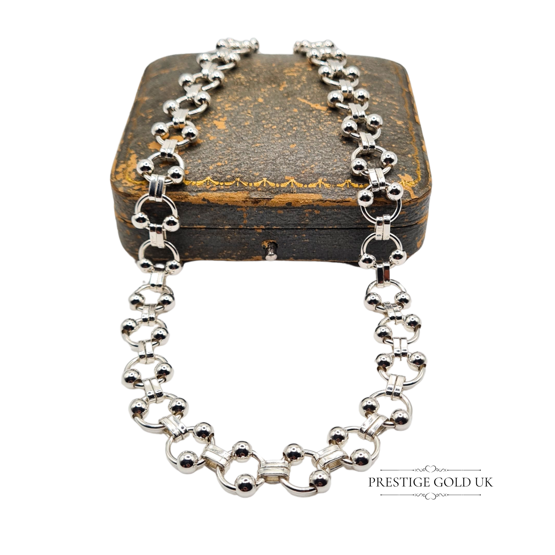 Close-up of a 925 silver fancy link necklace featuring spherical bead links and geometric connectors, 15 inches long and 10mm wide, with stamped lobster clasp
