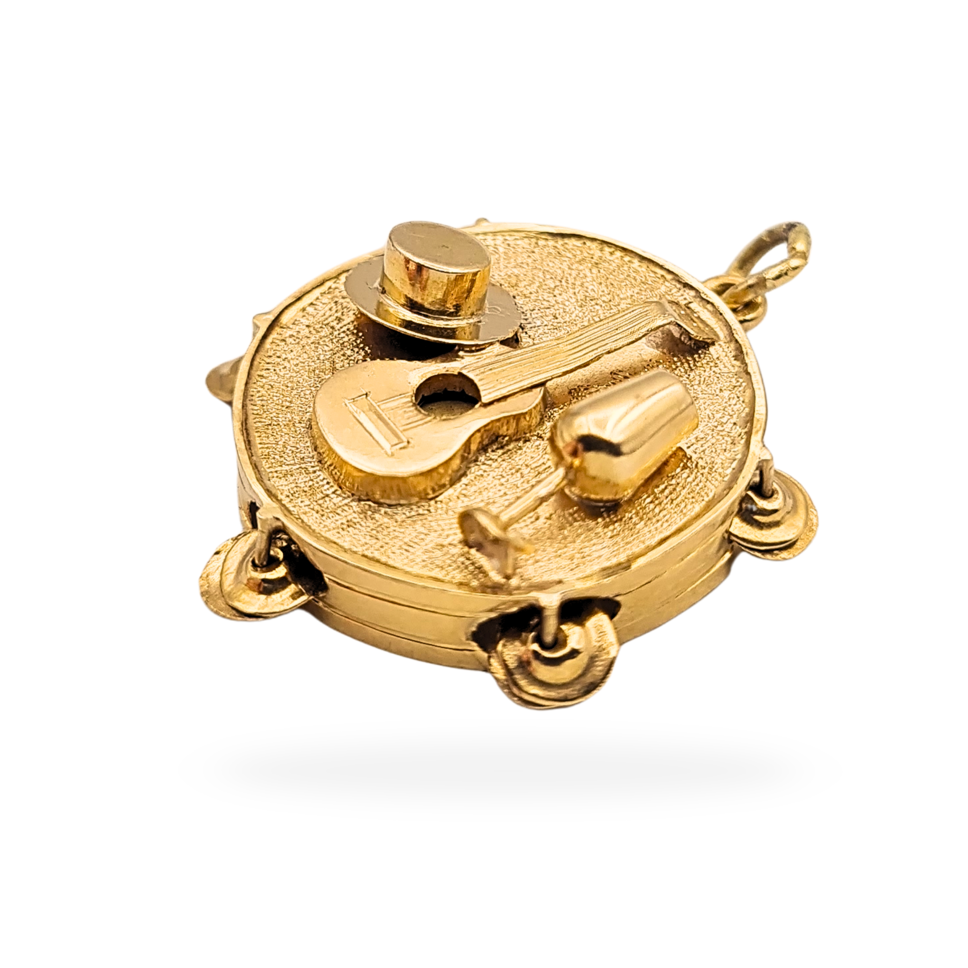 Vintage 9ct gold moving tambourine charm pendant with detailed guitar, hat and wine glass. Ornate textured musical design measuring approximately 22mm across and weighing 2.04g. Not hallmarked but fully tested as 9ct gold.