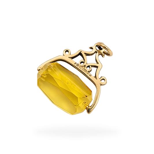 Vintage 9ct yellow gold citrine spinner fob pendant with London assay hallmarks dated 1977, featuring a faceted golden citrine that rotates within a decorative gold frame, measuring 17mm wide and 19mm tall, weighing 2.5g, classic moving fob charm.
