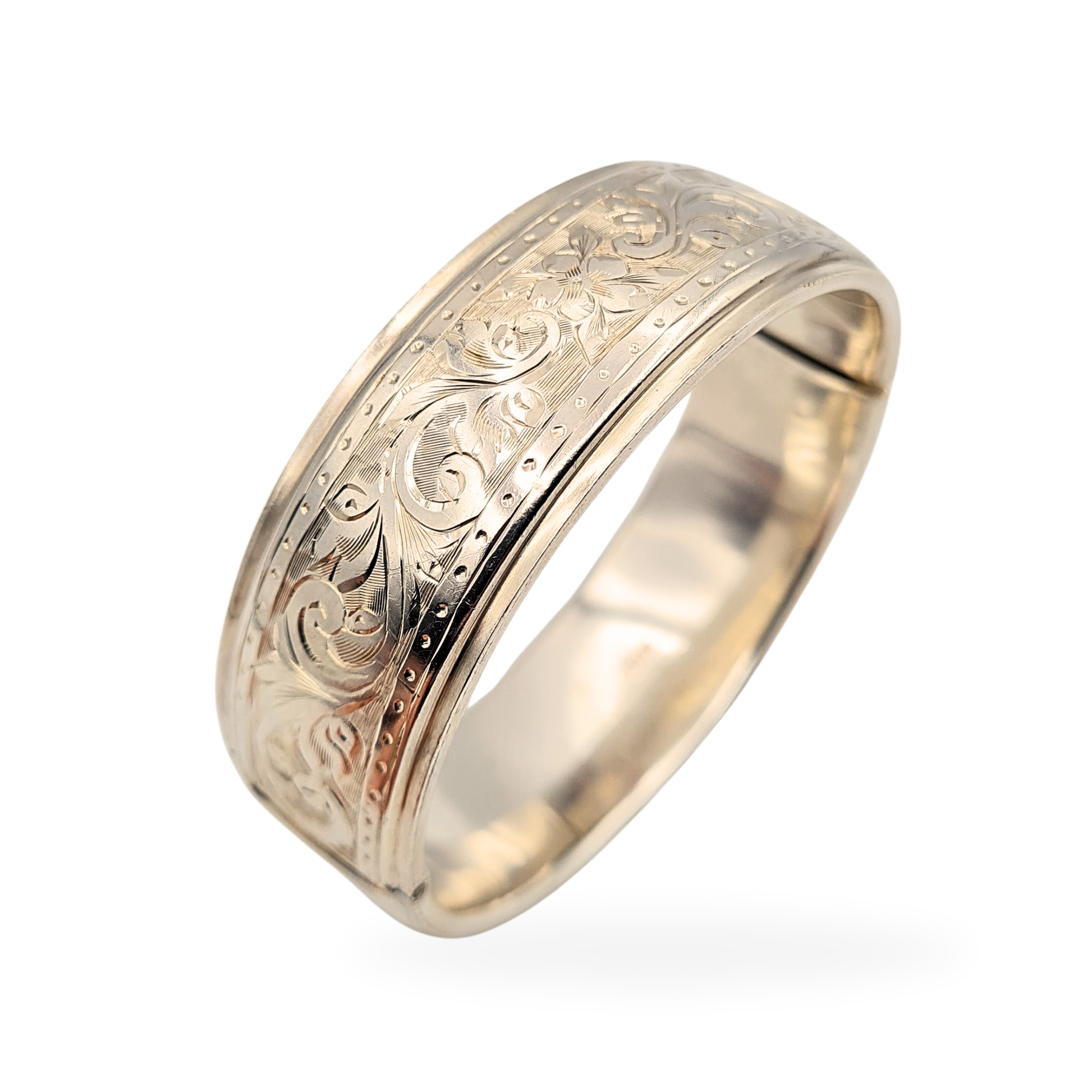 1984 Birmingham hallmarked sterling silver bangle featuring ornate floral engraving across a 20mm wide band, weighing 28.7g. This fully hallmarked 925 British silver bracelet measures 6 1/2" (16cm) long and showcases fine craftsmanship and rich detail.
