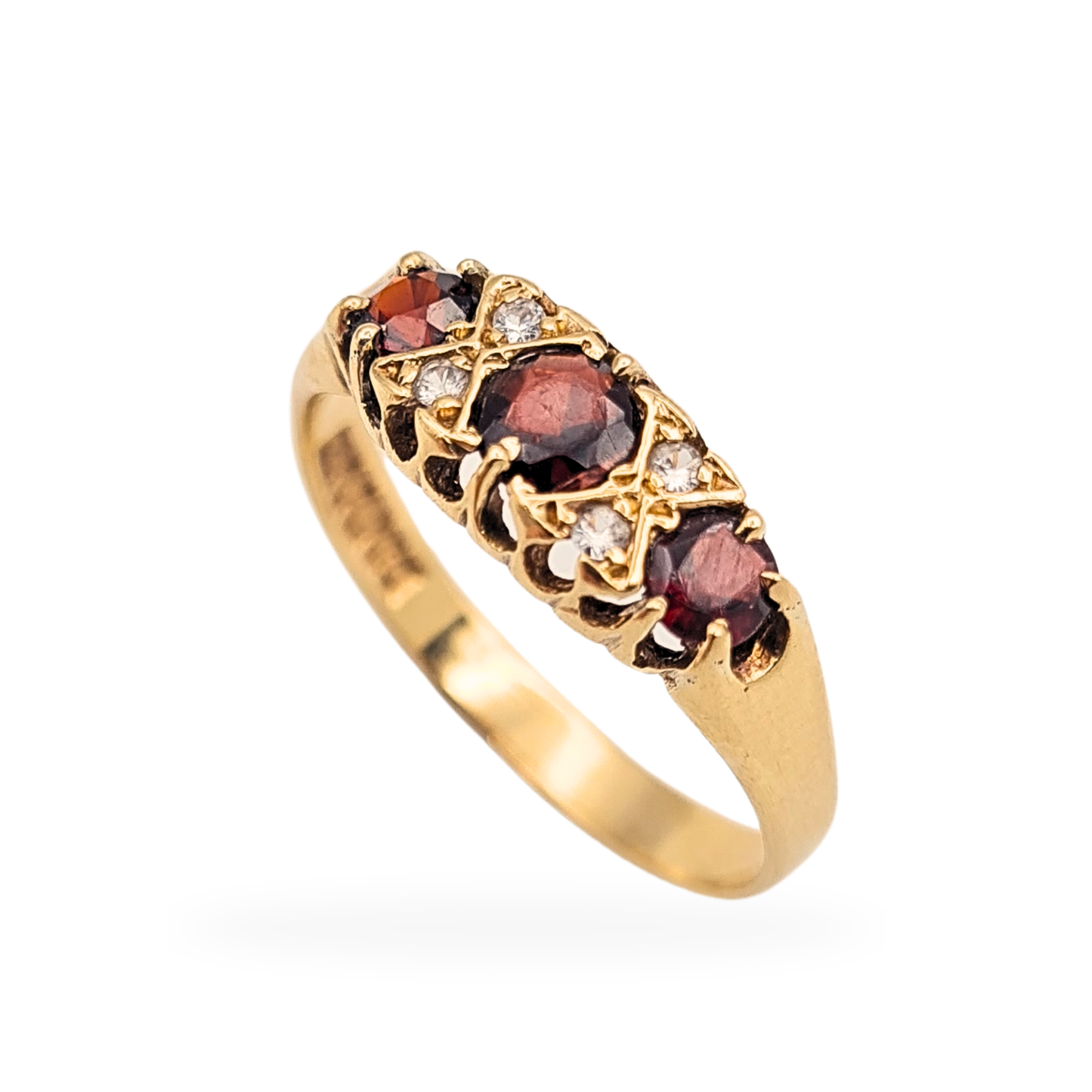 Vintage 9ct yellow gold garnet and cubic zirconia boat ring, fully British hallmarked London 1976, size UK R US 8 3/4. Featuring three deep red garnets with CZ accents across a 6.5mm wide face in a classic 1970s elongated setting, 2.3g.