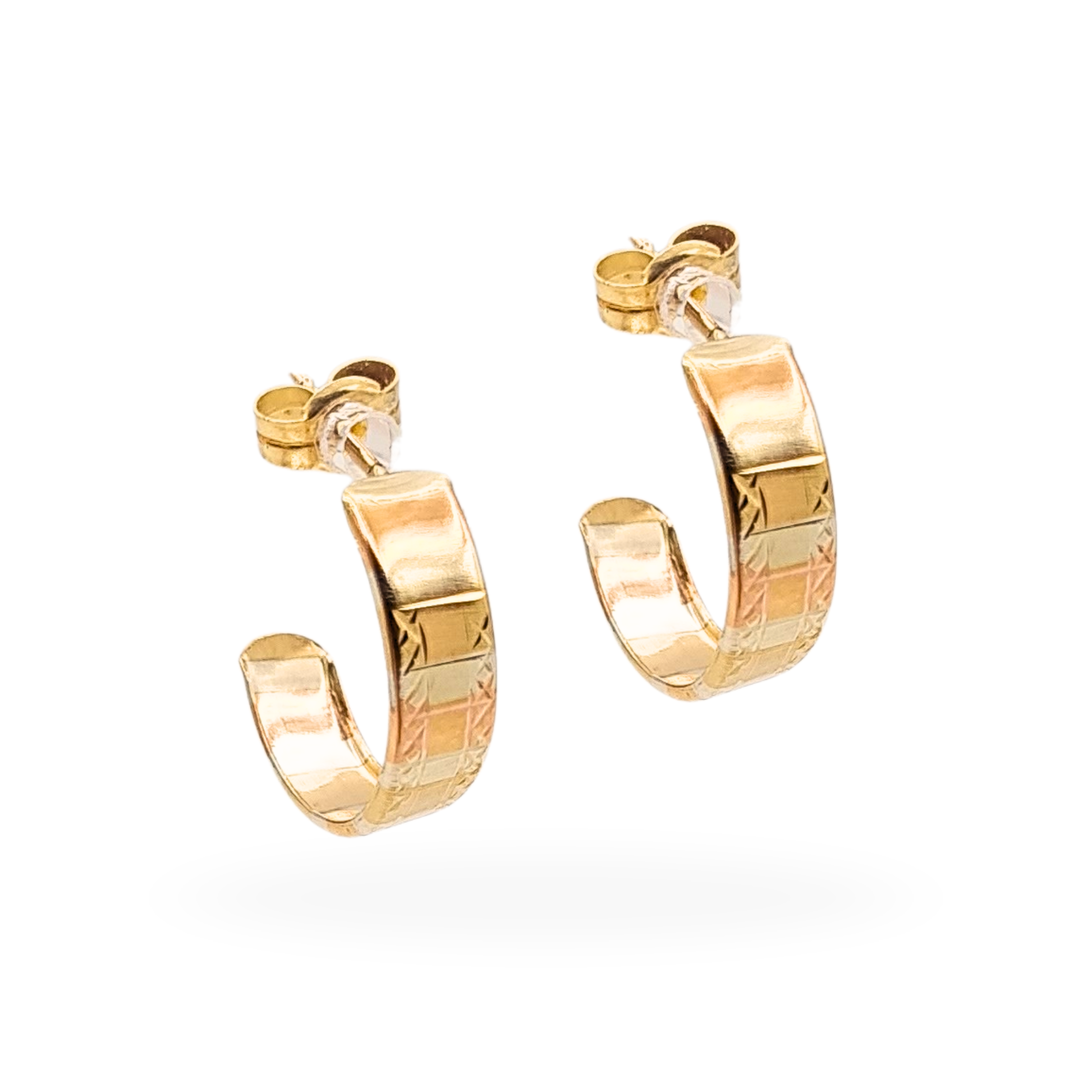 Pair of 9ct two-tone gold half hoop earrings with geometric engraved detailing, 15mm diameter and 4mm wide, weighing 0.75g. Tested solid gold with post and butterfly fittings, combining yellow and rose gold tones for a vintage look.