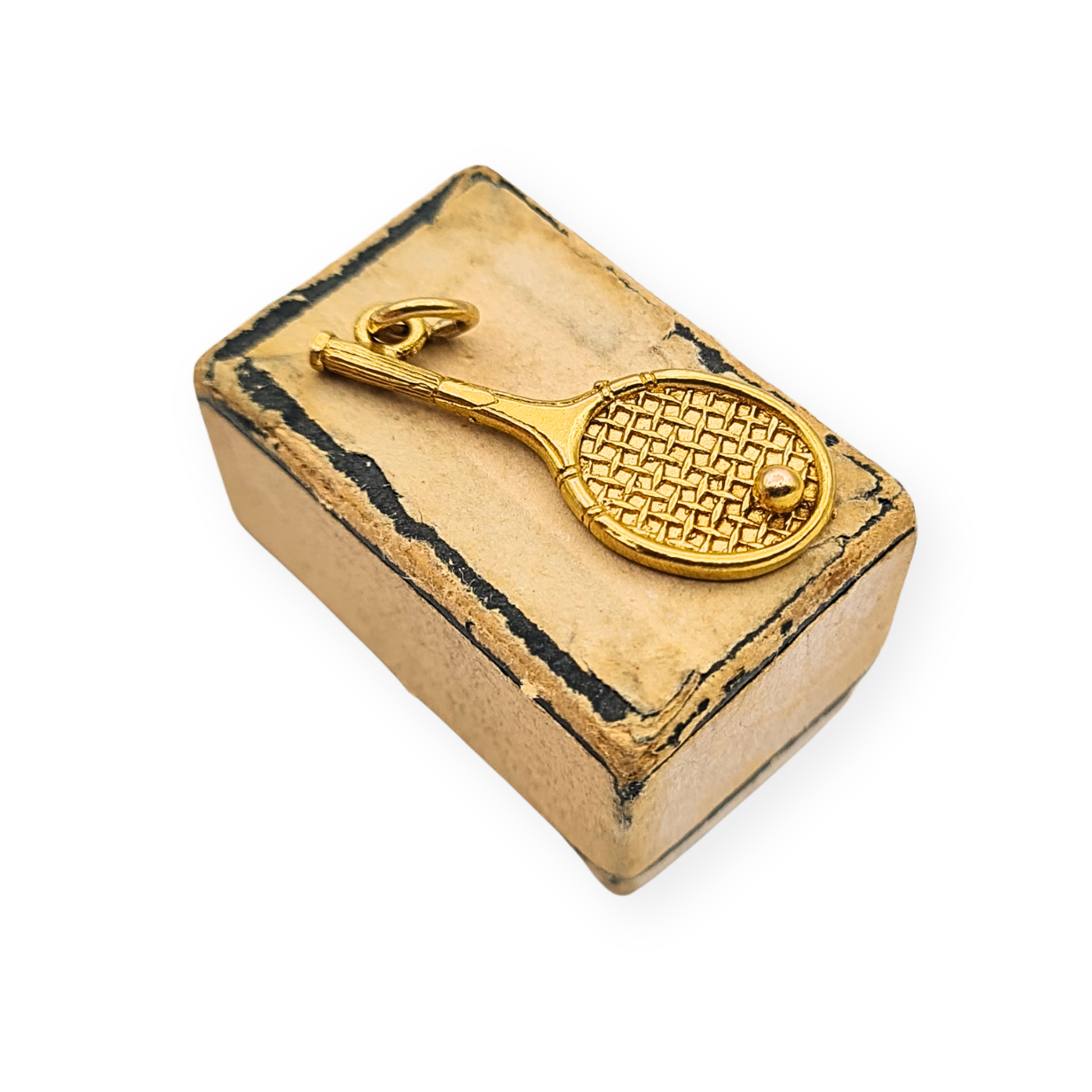 Vintage 9ct gold tennis racket and ball charm pendant measuring 25mm long, 10mm wide and 1mm thick, weighing 1.26g. Fully hallmarked Birmingham 1986, with detailed string pattern and raised ball, shown in close-up and scale images.
