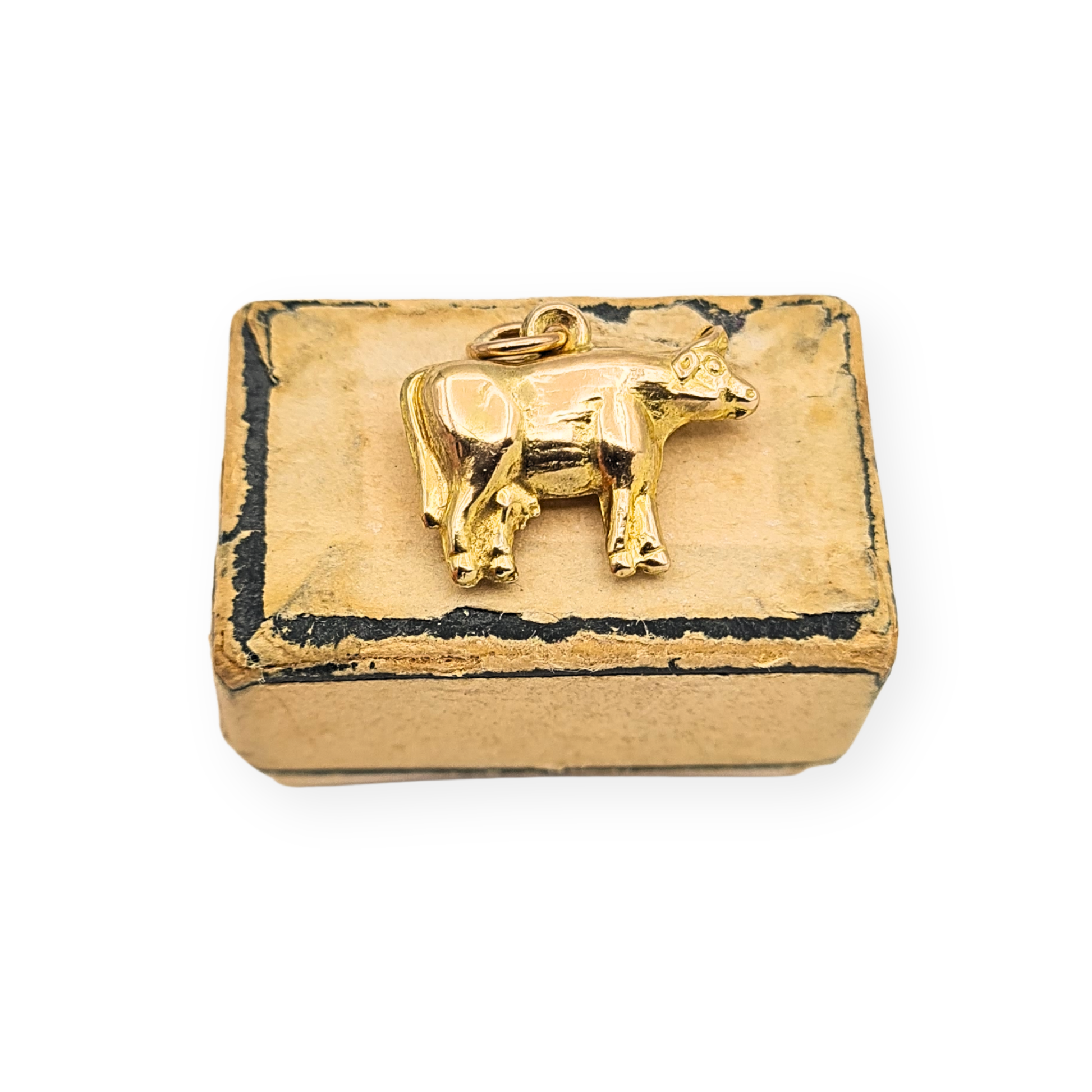 Small 9ct gold puffy cow charm measuring 16mm long, 11mm tall and 3.5mm wide, hollow construction and weighing 0.8g, stamped 9ct and fully tested. Polished gold farm animal pendant suitable for bracelet or fine chain, shown with scale and close-up hallmark detail.
