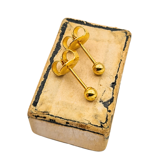 Pair of 9ct yellow gold ball stud earrings with polished 2mm bead heads and straight 10mm posts, fitted with secure butterfly backs. Fully hallmarked with 375 stamp, lightweight at 0.4g, shown on ear and in vintage presentation box.