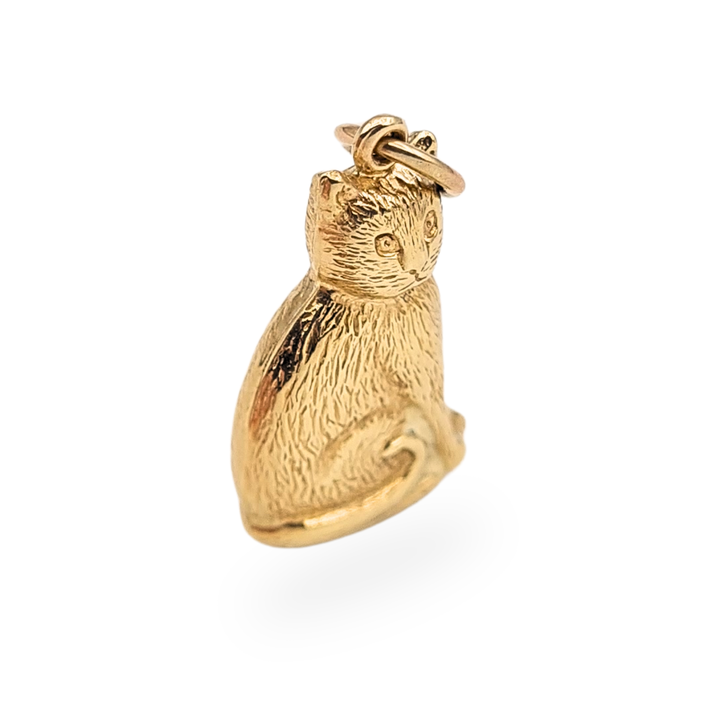 Vintage 9ct gold puffy sitting cat charm pendant with Birmingham 1993 hallmark. Small hollow construction gold feline charm measuring approximately 19mm tall and weighing 0.90g, with textured fur detail and integrated bail for a chain.