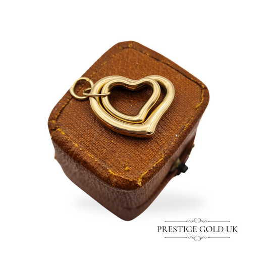 A lightweight 9ct gold twin hollow heart pendant, featuring smooth edges and an open jump ring, perfect for necklaces or charm bracelets.