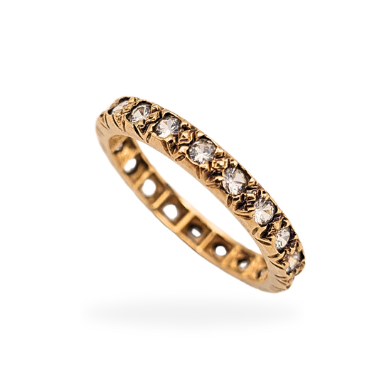 9ct gold full eternity ring set with clear spinel stones, fully tested for gold purity, shown in close detail to highlight the continuous stone setting, decorative gallery, slim 2.8mm band width, and UK size L 1/2 US size 6 1/4 in very good condition.
