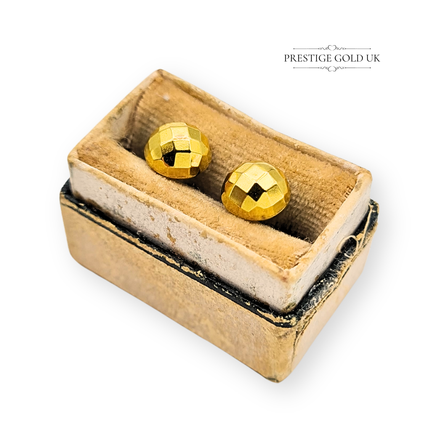 Pair of small round 9ct yellow gold faceted dome stud earrings hallmarked London 1979, stamped 375, with butterfly backs and 7mm faces, polished vintage geometric design photographed by Prestige Gold UK on antique props.