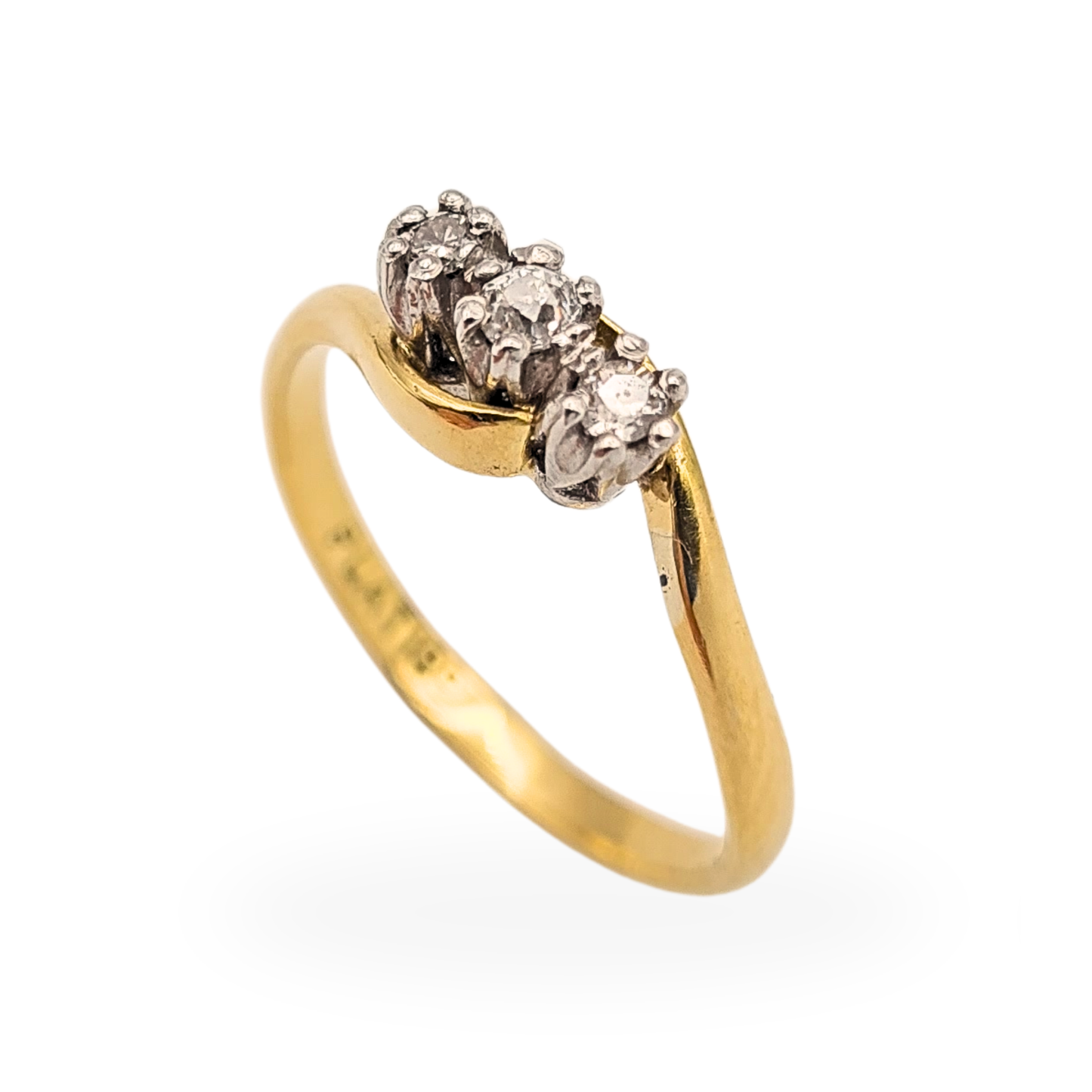 18ct gold crossover ring with three round diamonds set in platinum, stamped Plat 18ct, UK size N, elegant twist band design with raised trilogy setting, classic fine jewellery piece with contrasting yellow gold and white metal settings