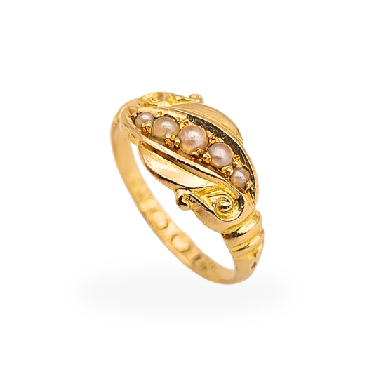 Antique 18ct gold pinky ring with five graduating seed pearls and elegant scrolling shoulders, circa 1900.