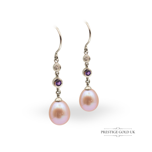 Pair of 9ct white gold drop earrings featuring pink freshwater pearls, bezel-set diamonds and amethysts, 35mm long with 9mm wide pearls, elegant and luxurious design.